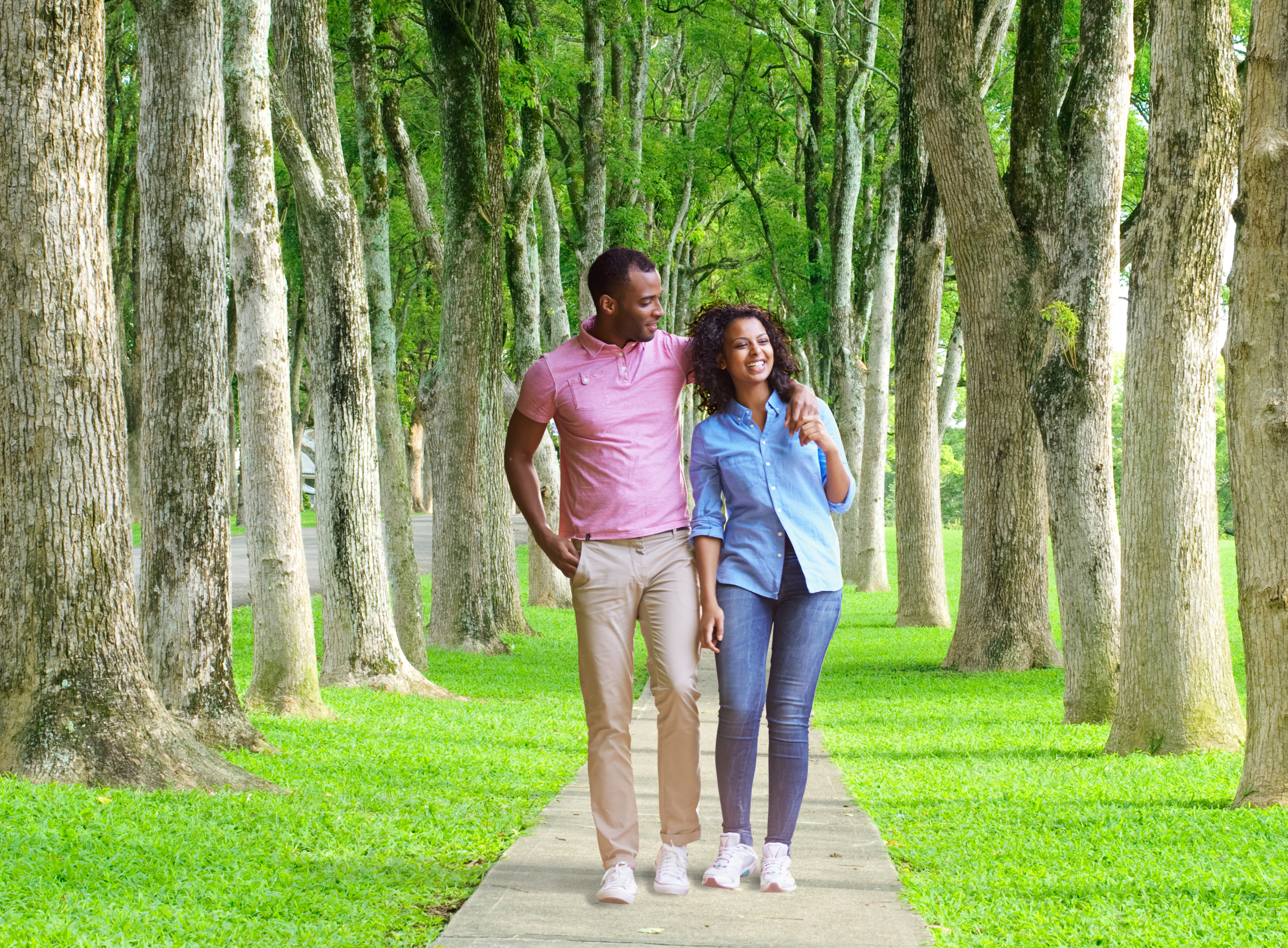 March 30 Special Events - Take A Walk Day. Image of a couple walking in a park hand in hand. Green grass surrounding them with tall trees. 